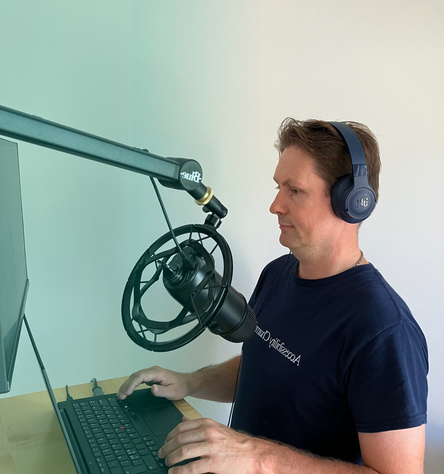 Person with headphones at a computer